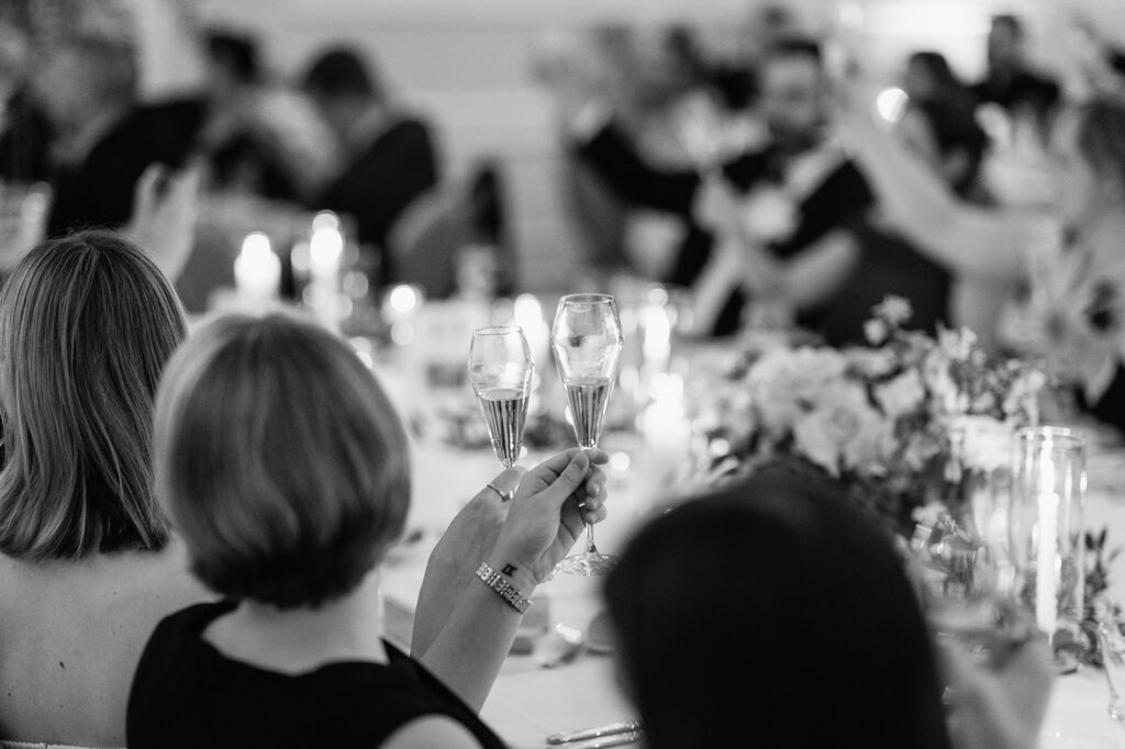 Black and white photo of guests toasting