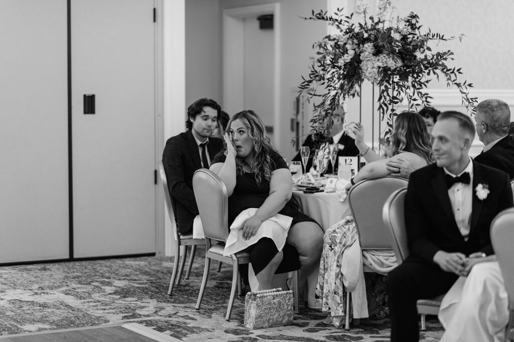 Black and white photo of guests getting emotional during speeches