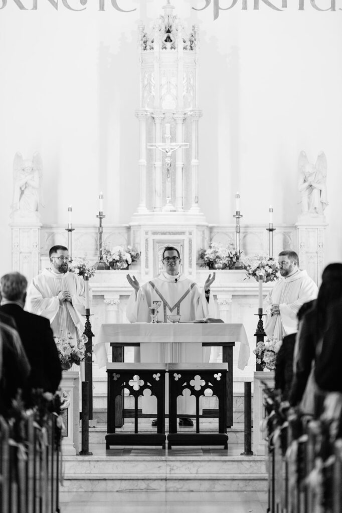 Priest leads the nuptial mass at the ornate altar inside The Holy Spirit Chapel at Notre Dame.