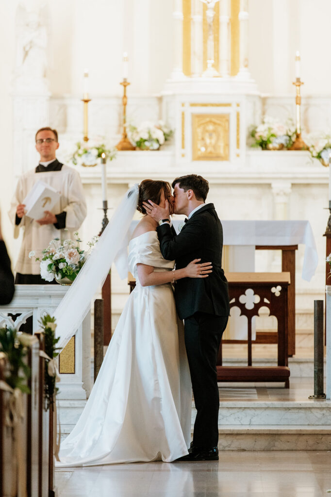 Bride and groom share their first kiss as husband and wife inside The Holy Spirit Chapel at Notre Dame.