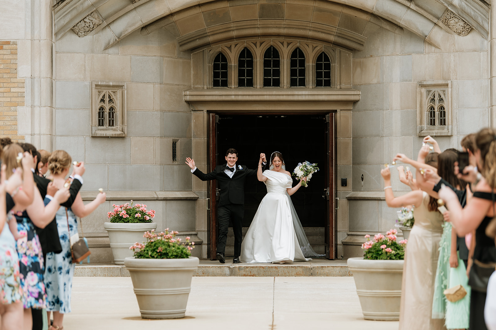 Bride and grooms grand exit from their Notre Dame wedding ceremony at at The Holy Spirit Chapel