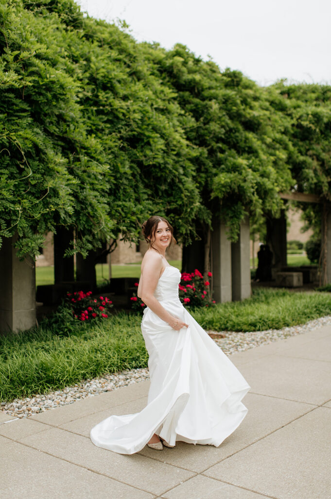 Bride twirling on campus for her Notre Dame wedding portraits