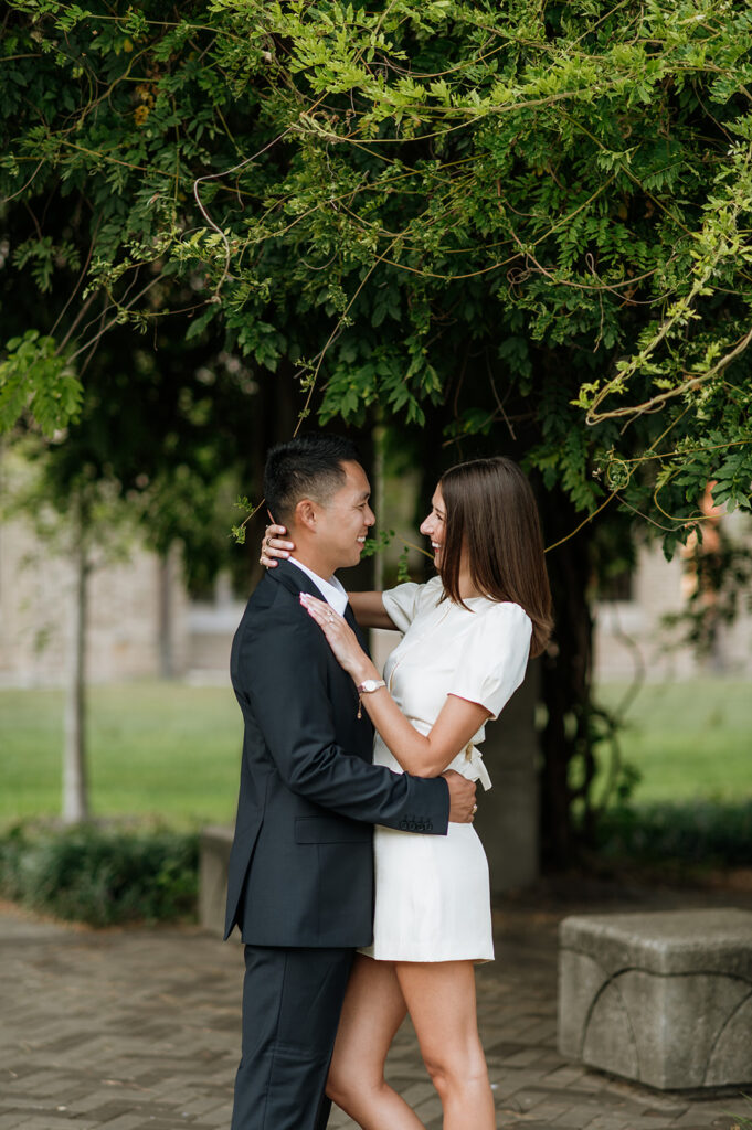 Couple embracing near ivy-covered columns at the University of Notre Dame.