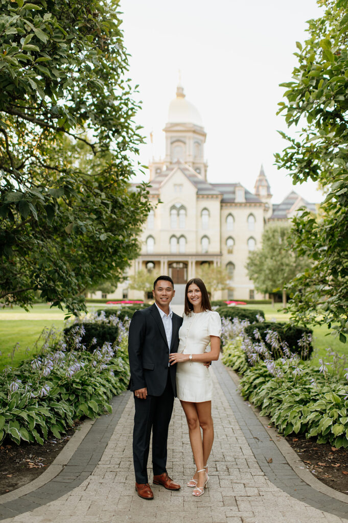 Couple posing with the Main Building and golden dome in the background.