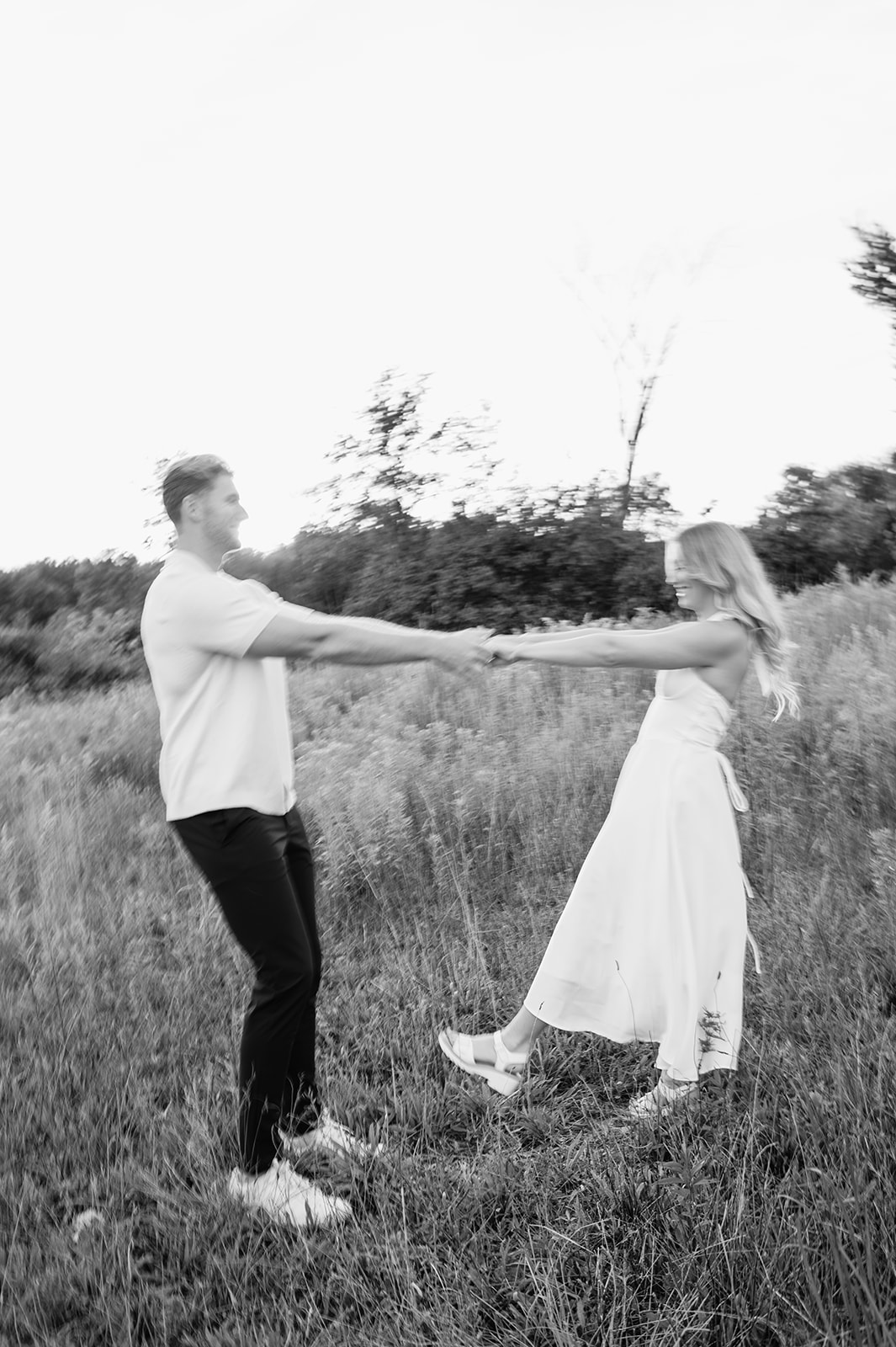 Black and white motion blur photo of a couple dancing in the fields during golden hour in Goshen, Indiana
