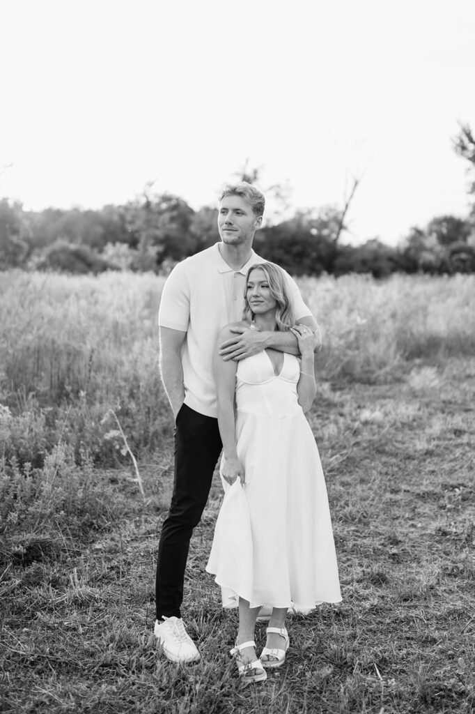 Black and white photo of a couple posing in a field