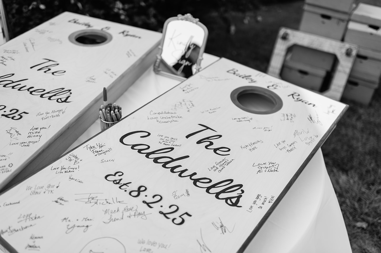 Custom cornhole boards signed by guests for Ryan and Bailey’s wedding day at Rock Run Creek Barn in Indiana.