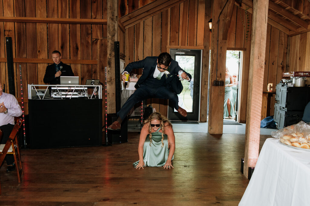 Bridesmaid and groom entering the reception