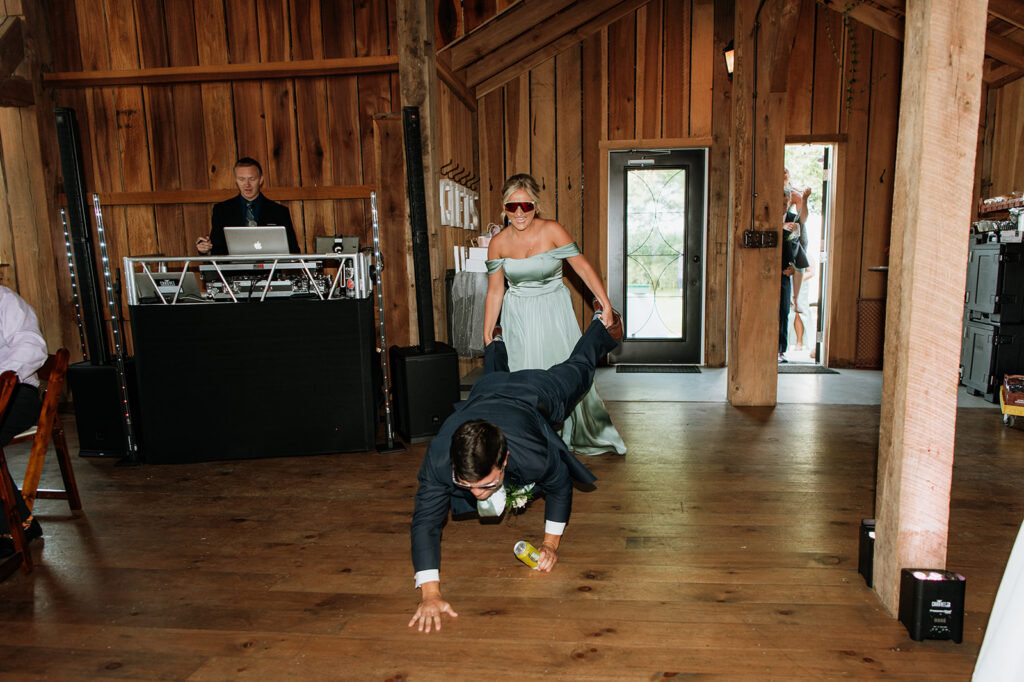 Bridesmaid and groom entering the reception