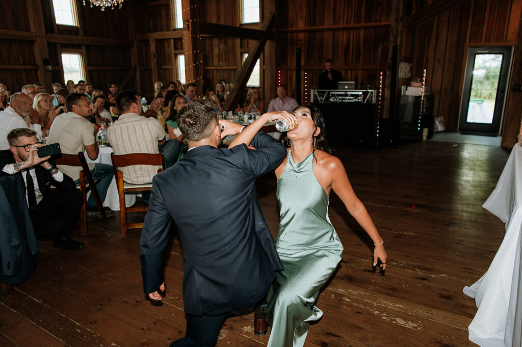 Bridesmaid and groomsmen chugging beer
