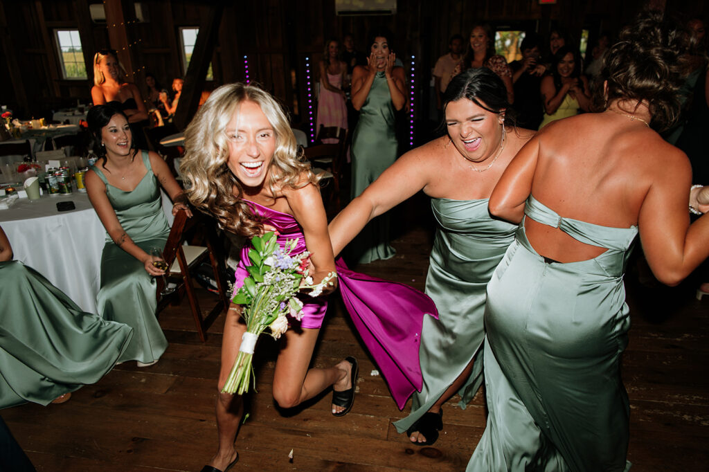 Bridesmaids running to catch the bouquet