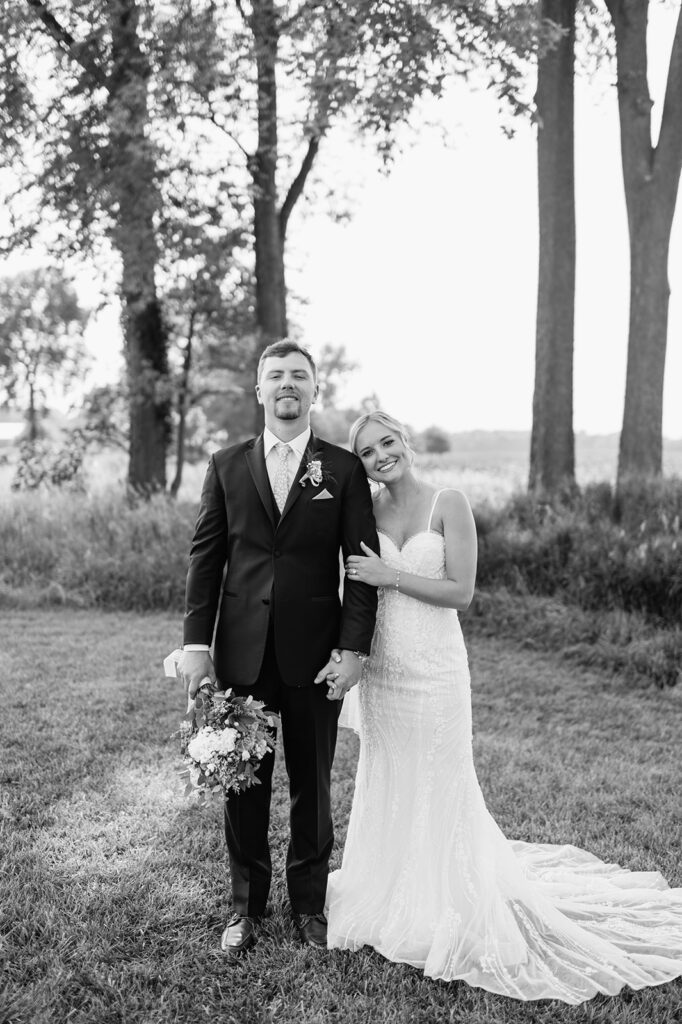  Black and white photo of a bride and groom posing together at Rock Run Creek Barn wedding venue.
