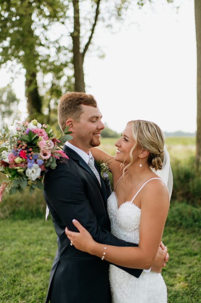 Bride and groom sharing a laugh during golden hour at Rock Run Creek Barn wedding.