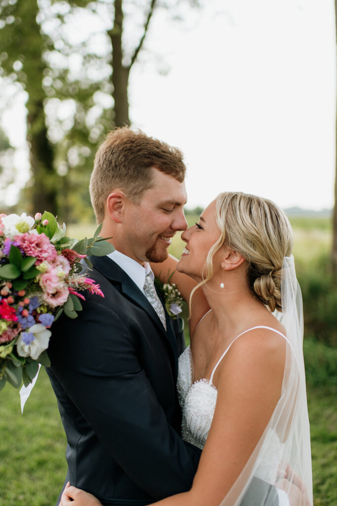 Couple forehead to forehead during golden hour portraits.