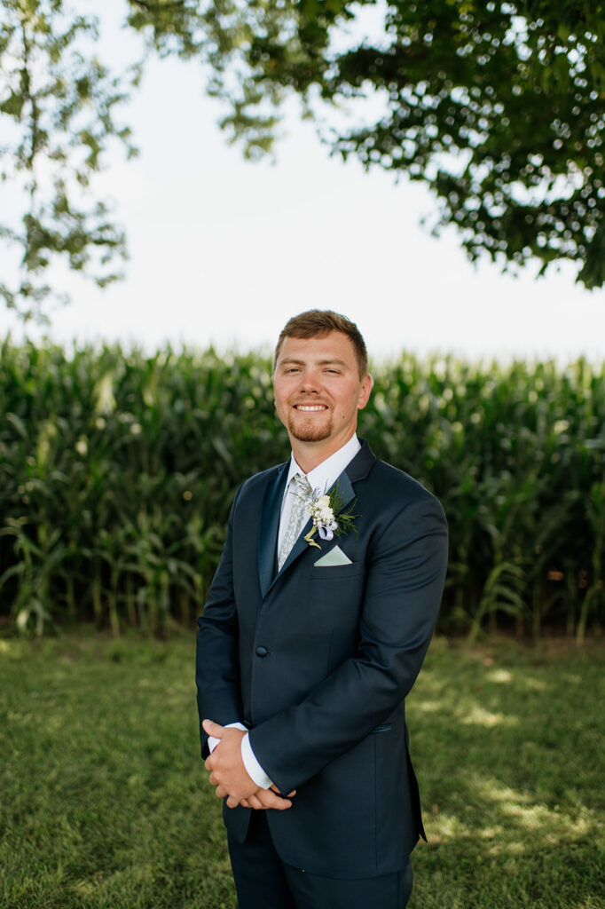 Outdoor grooms portrait in front of a cornfield at Rock Run Creek Barn in Goshen, Indiana