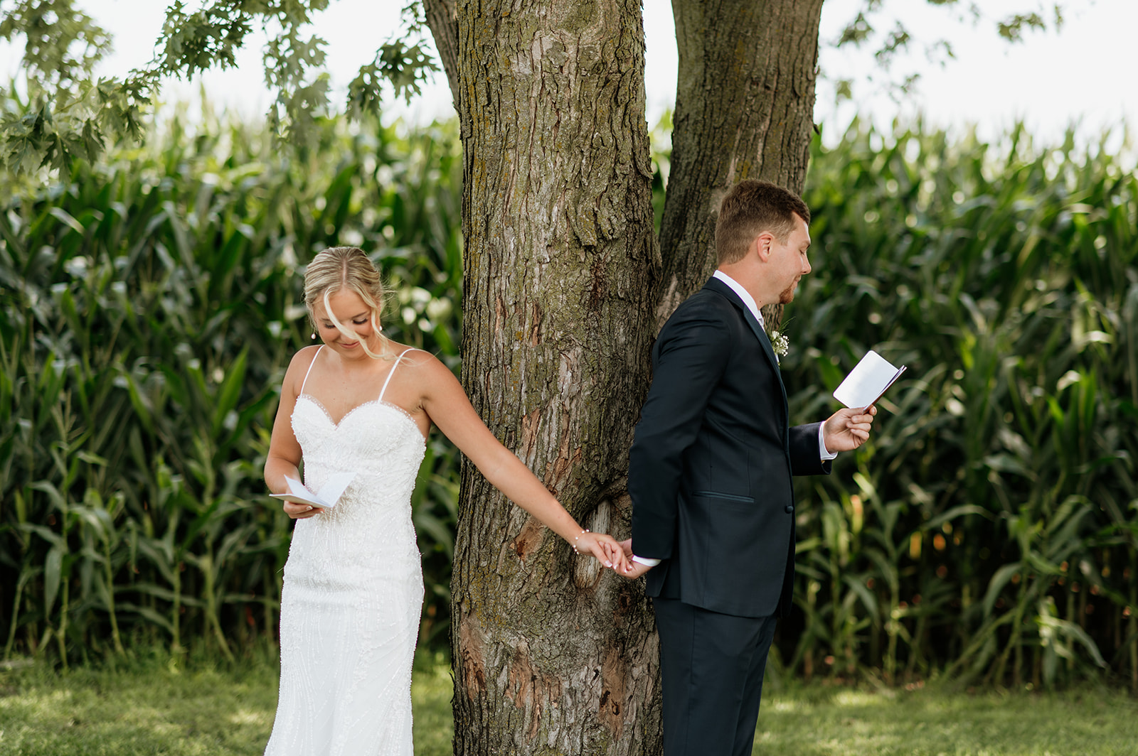 Couple reading private vows under the trees at Rock Run Creek Barn wedding.
