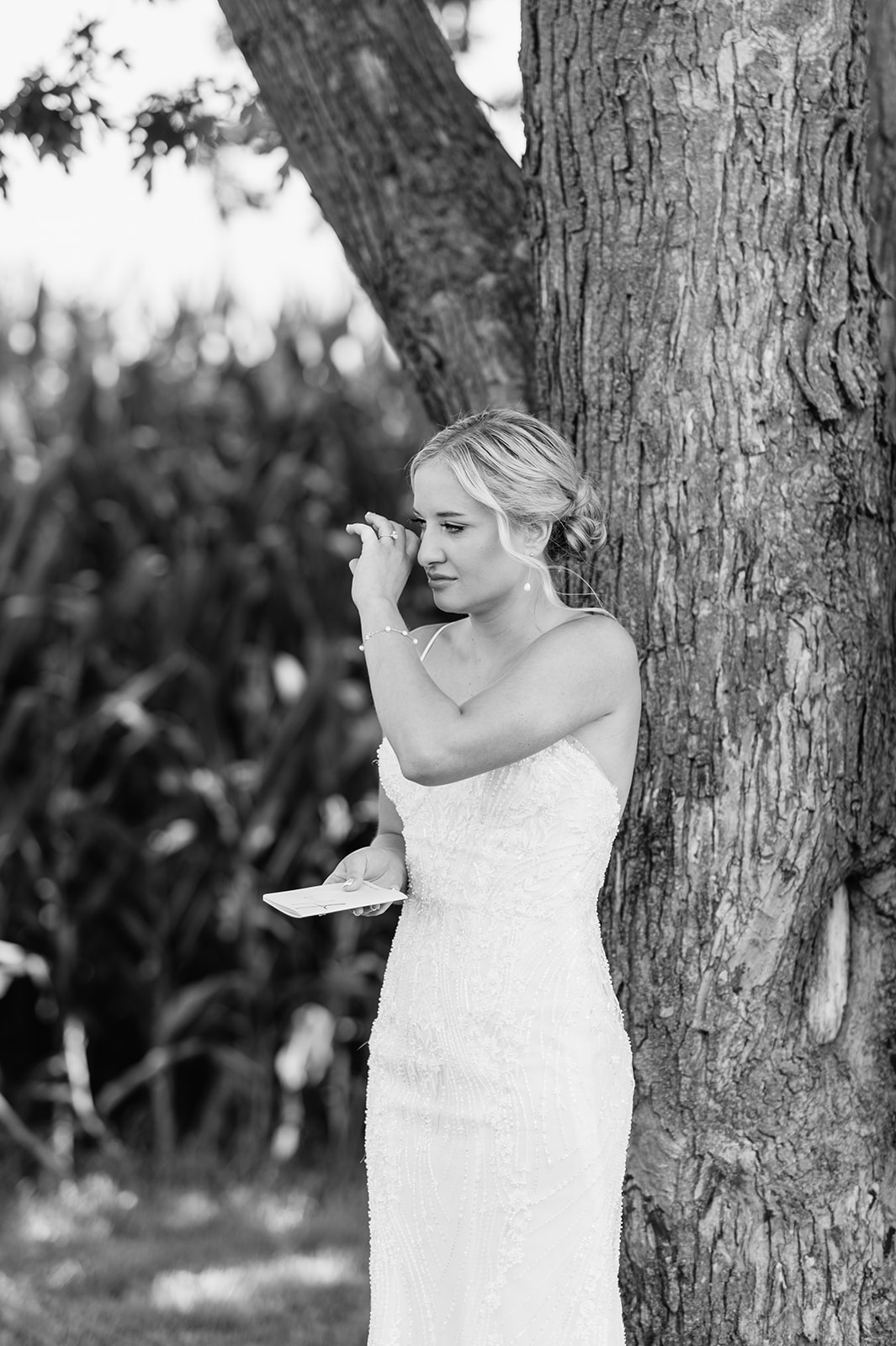 Bride wiping away tears during private vow exchange before the ceremony.