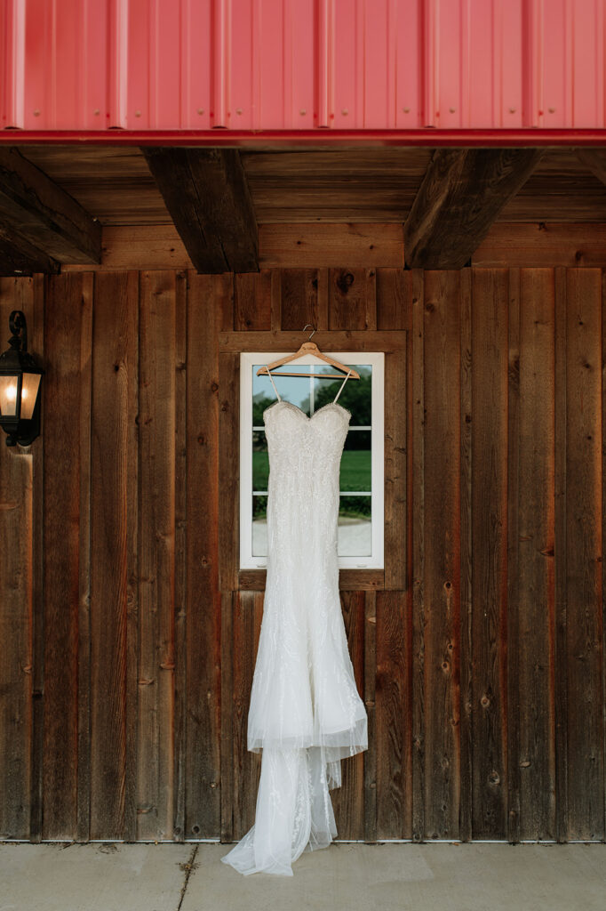 Brides wedding dress hanging at Rock Run Creek Barn in Goshen