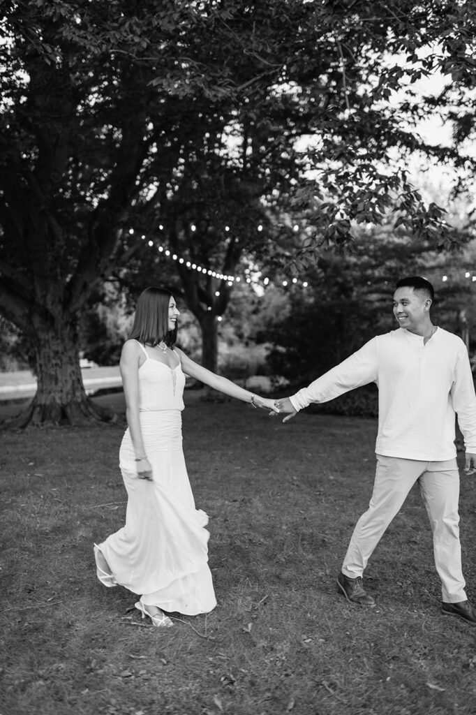 Romantic black and white photo of couple walking across the lawn for their Saint Mary’s College session.