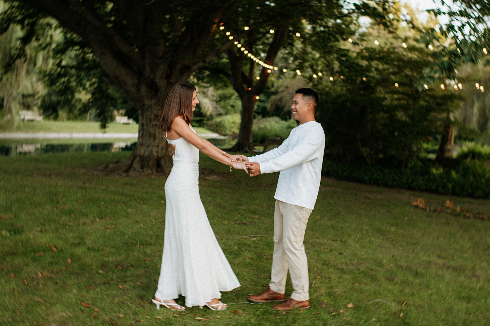 Couple dancing together on the lawn during golden hour Saint Mary’s College engagement photos.