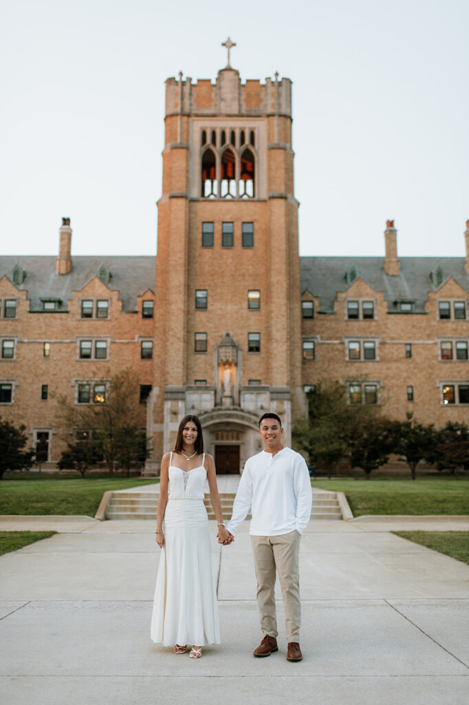 Couple posing in front of the historic LeMans Hall building during Saint Mary’s College engagement photos.