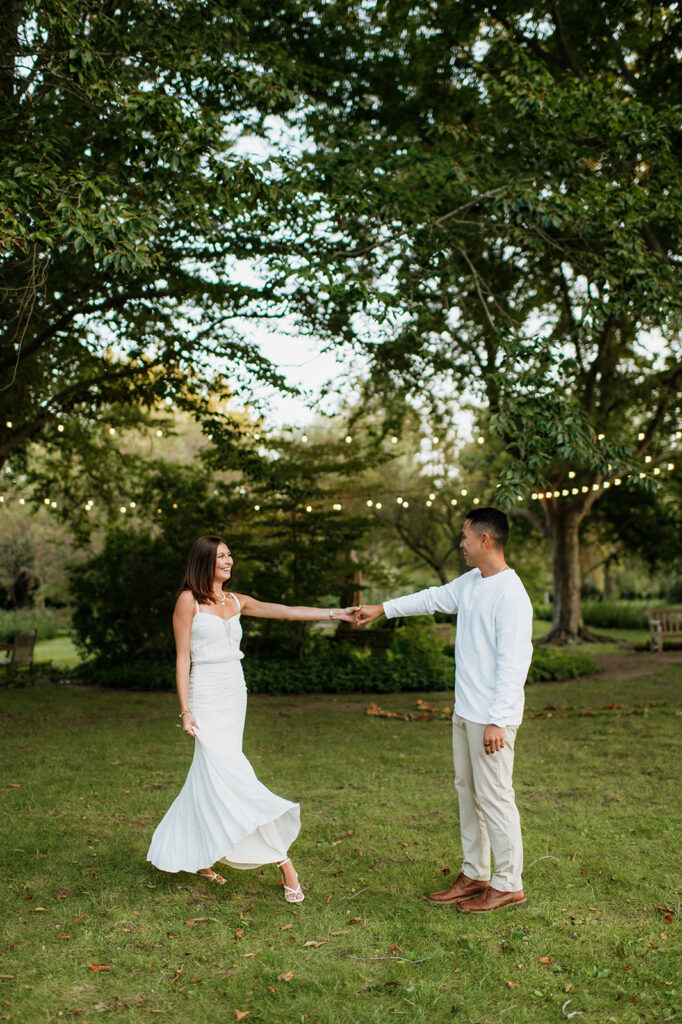 Couple dancing together on the lawn during golden hour Saint Mary’s College engagement photos.