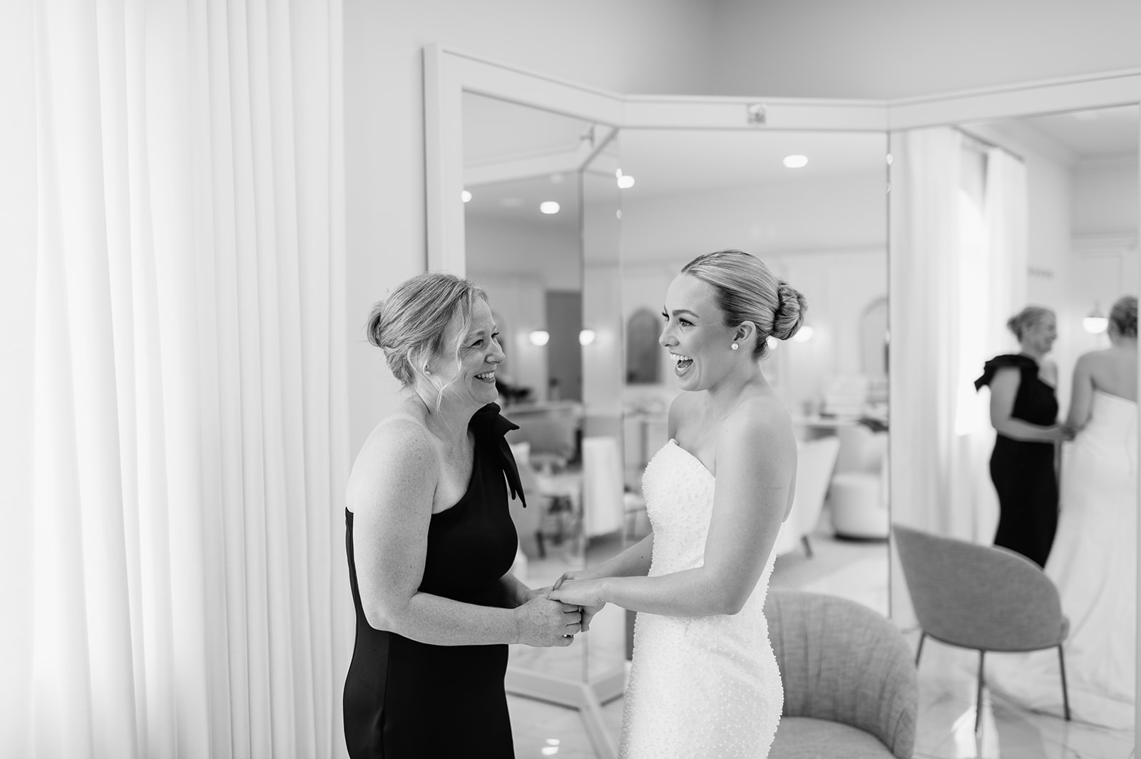 Bride laughing with her mom while getting ready at The Clubhouse Venue.