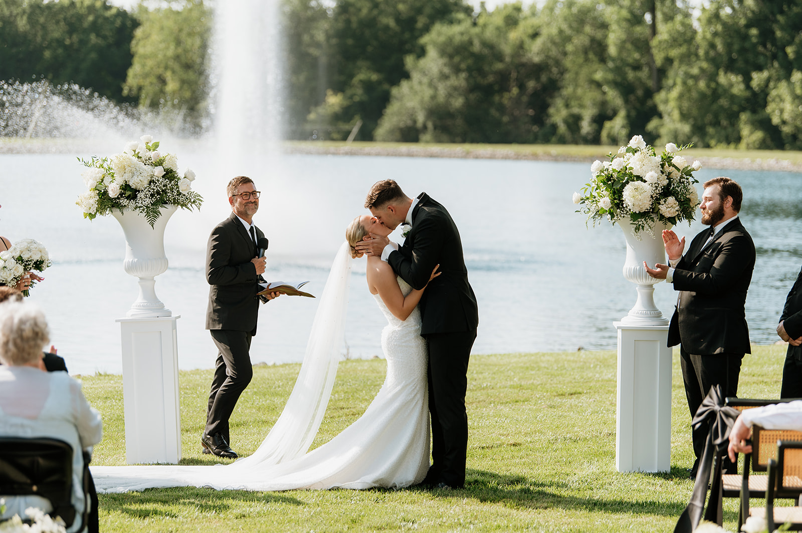 Bride and groom sharing their first kiss at the outdoor ceremony at The Clubhouse Venue.