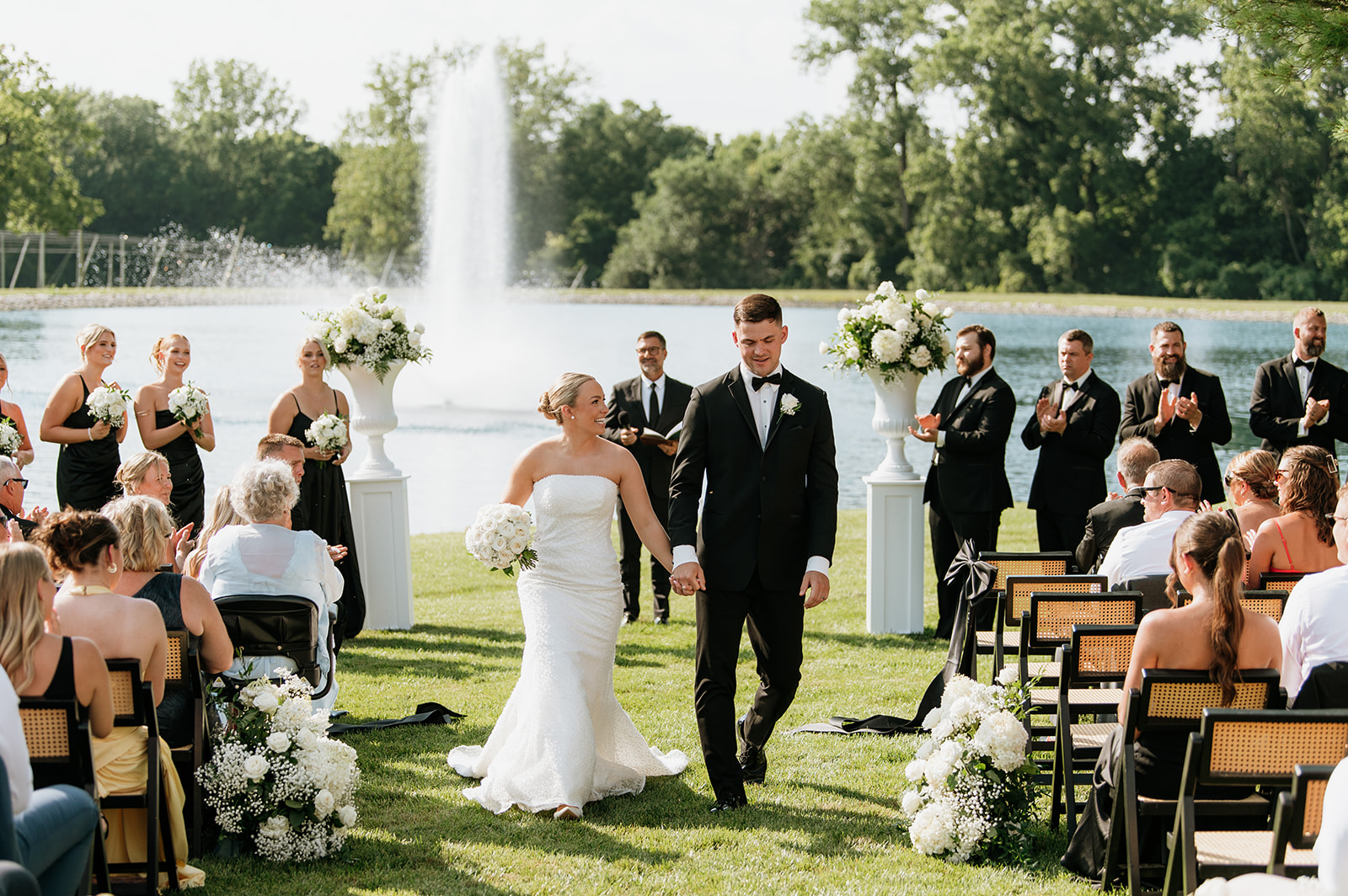 Bride and groom walking back down the aisle as husband and wife after their Clubhouse Venue wedding ceremony