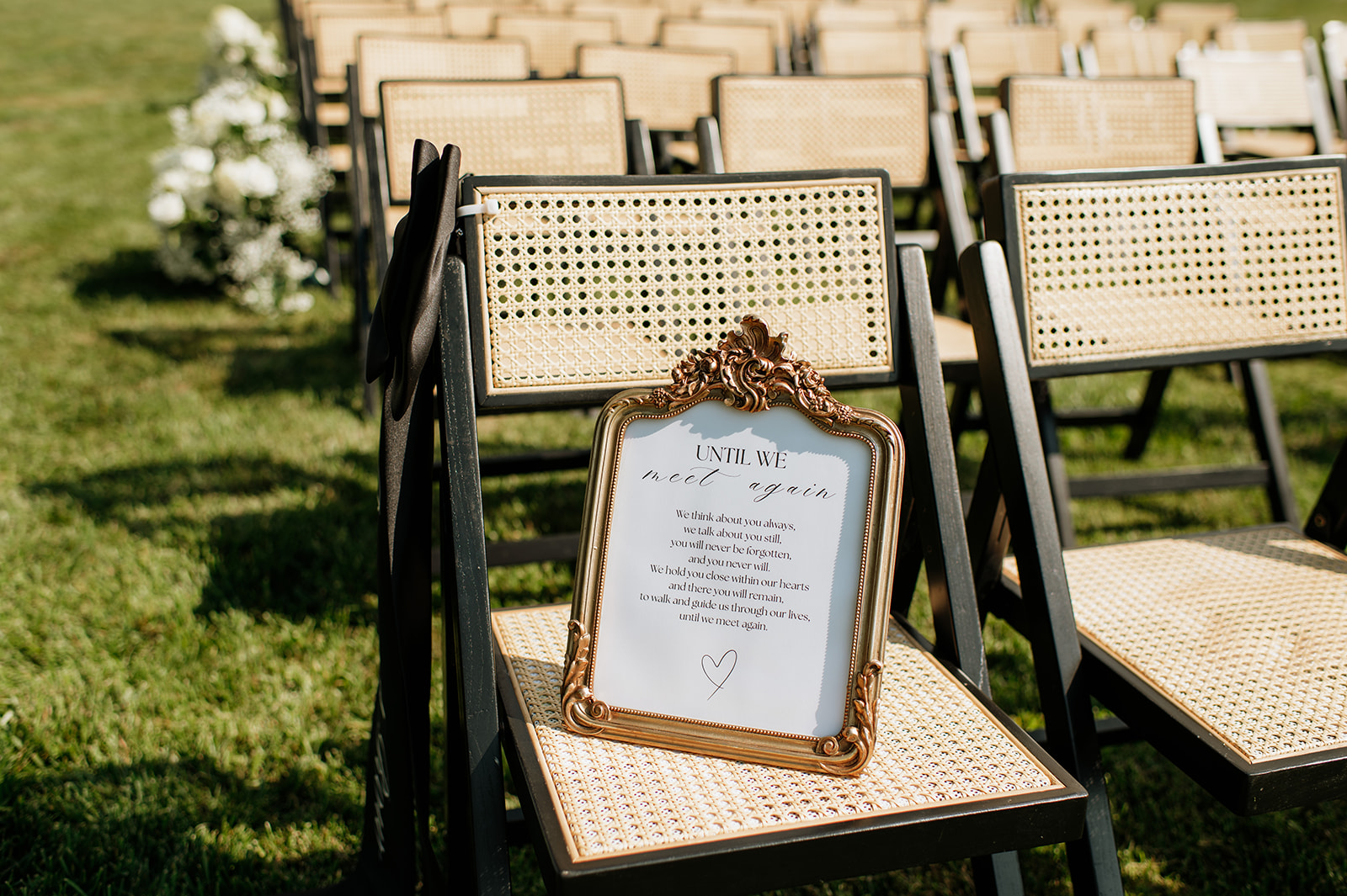 Memorial sign displayed on a ceremony chair at The Clubhouse Venue.