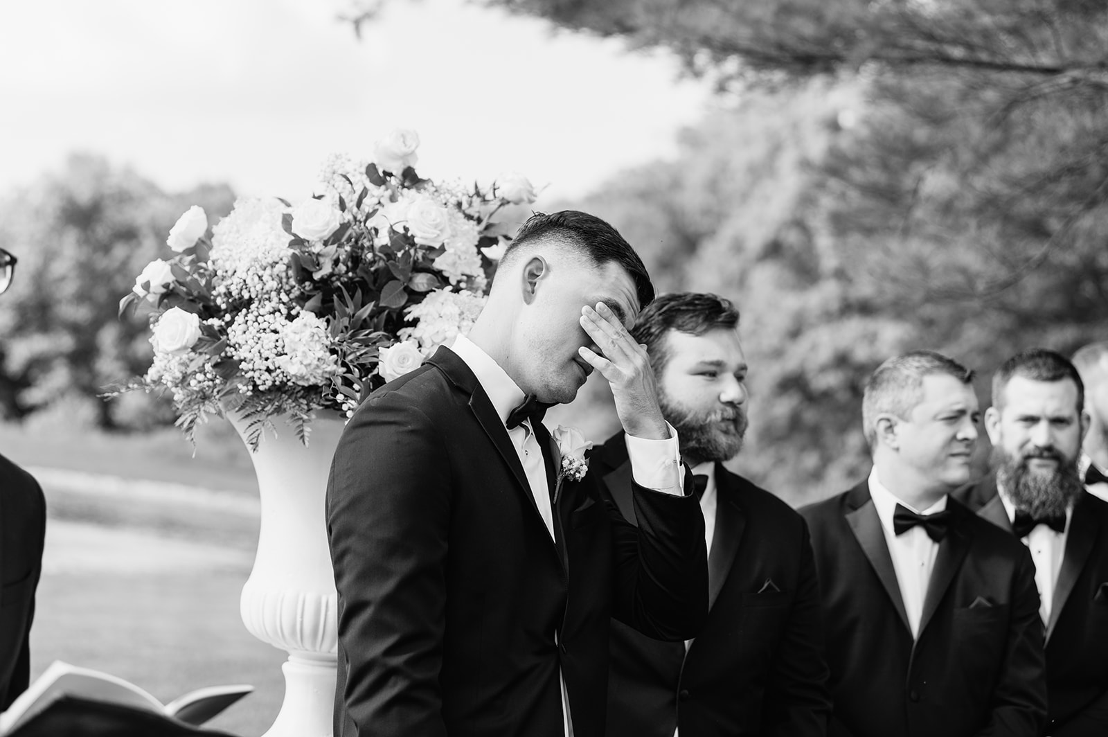 Groom wiping away tears as he sees the bride during the ceremony at The Clubhouse Venue.