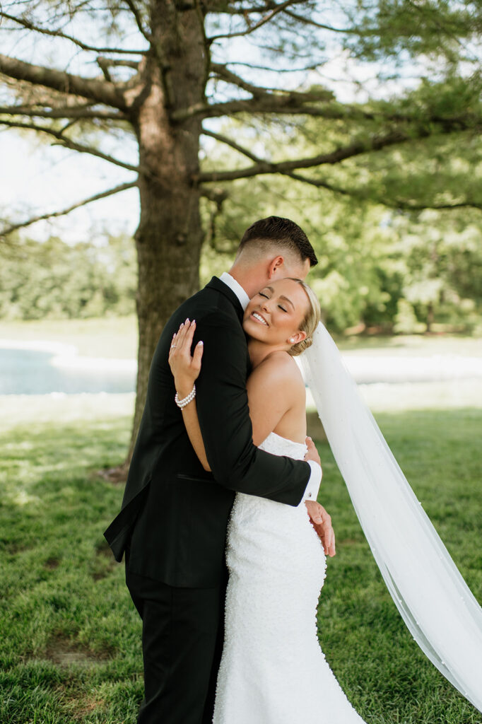 Bride and groom sharing a hug after their first look at The Clubhouse Venue.