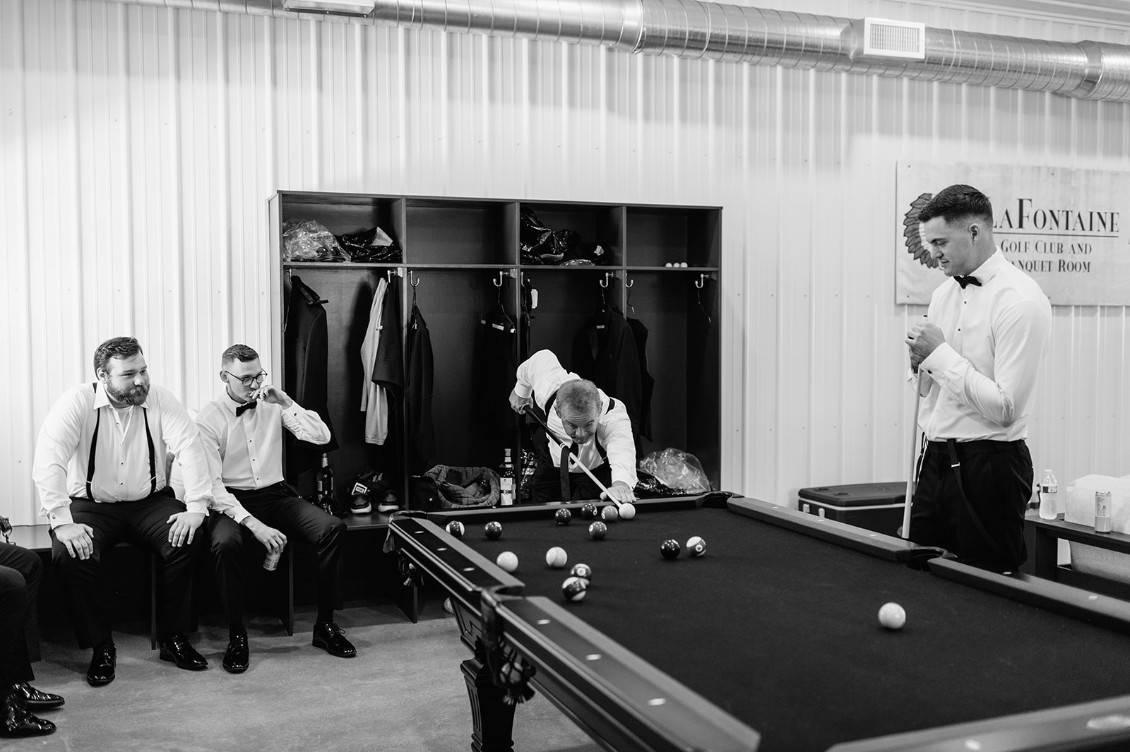 Groomsmen playing pool and getting ready in the Groomsmen Suite at The Clubhouse Venue.