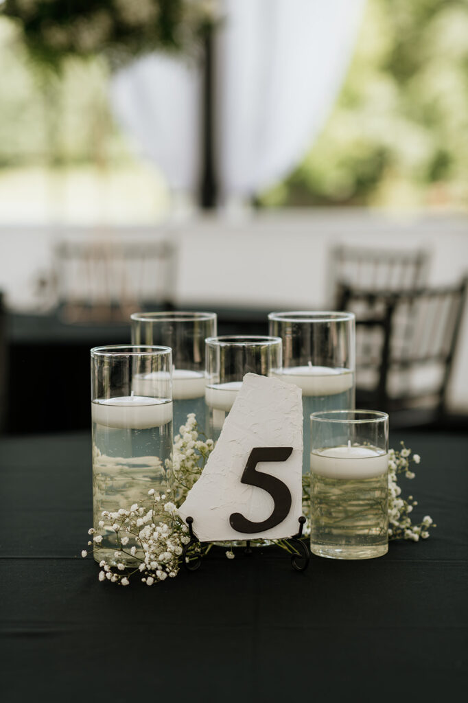 5 floating candles for the 5th table at The Clubhouse venue wedding reception