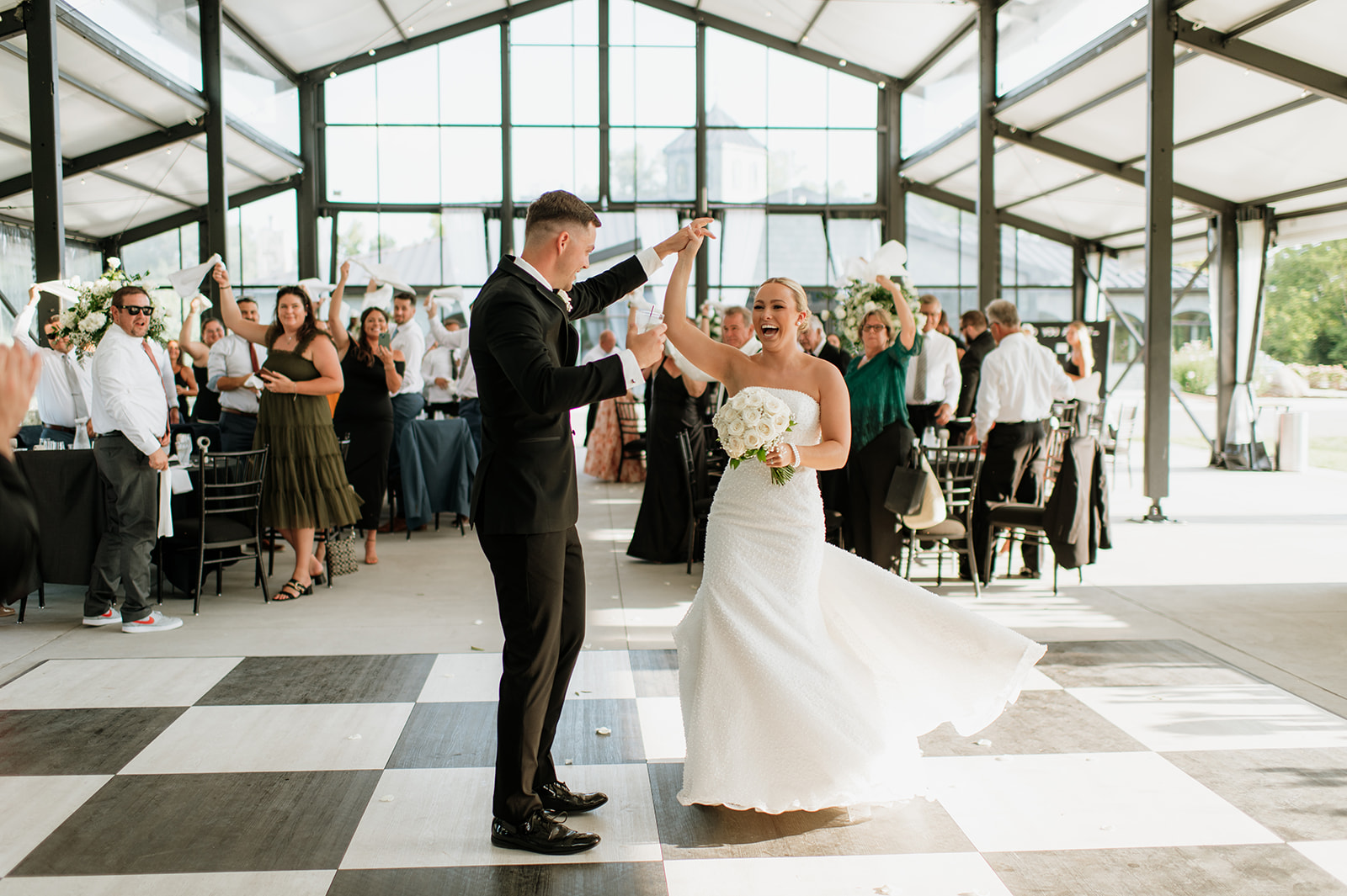 Bride and groom first dance inside The Clubhouse Venue reception hall.