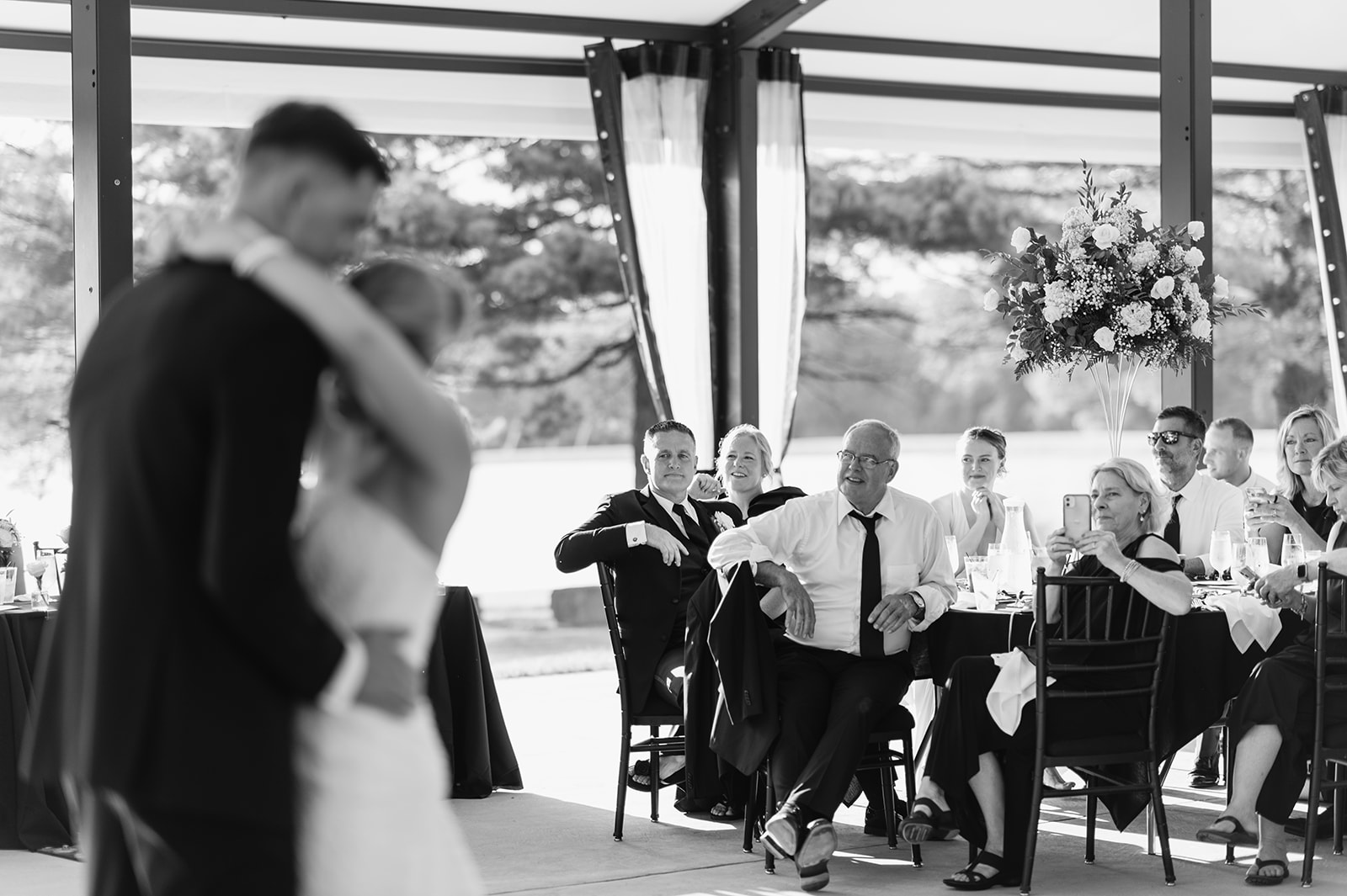 Guests watching as the bride and groom share a first dance