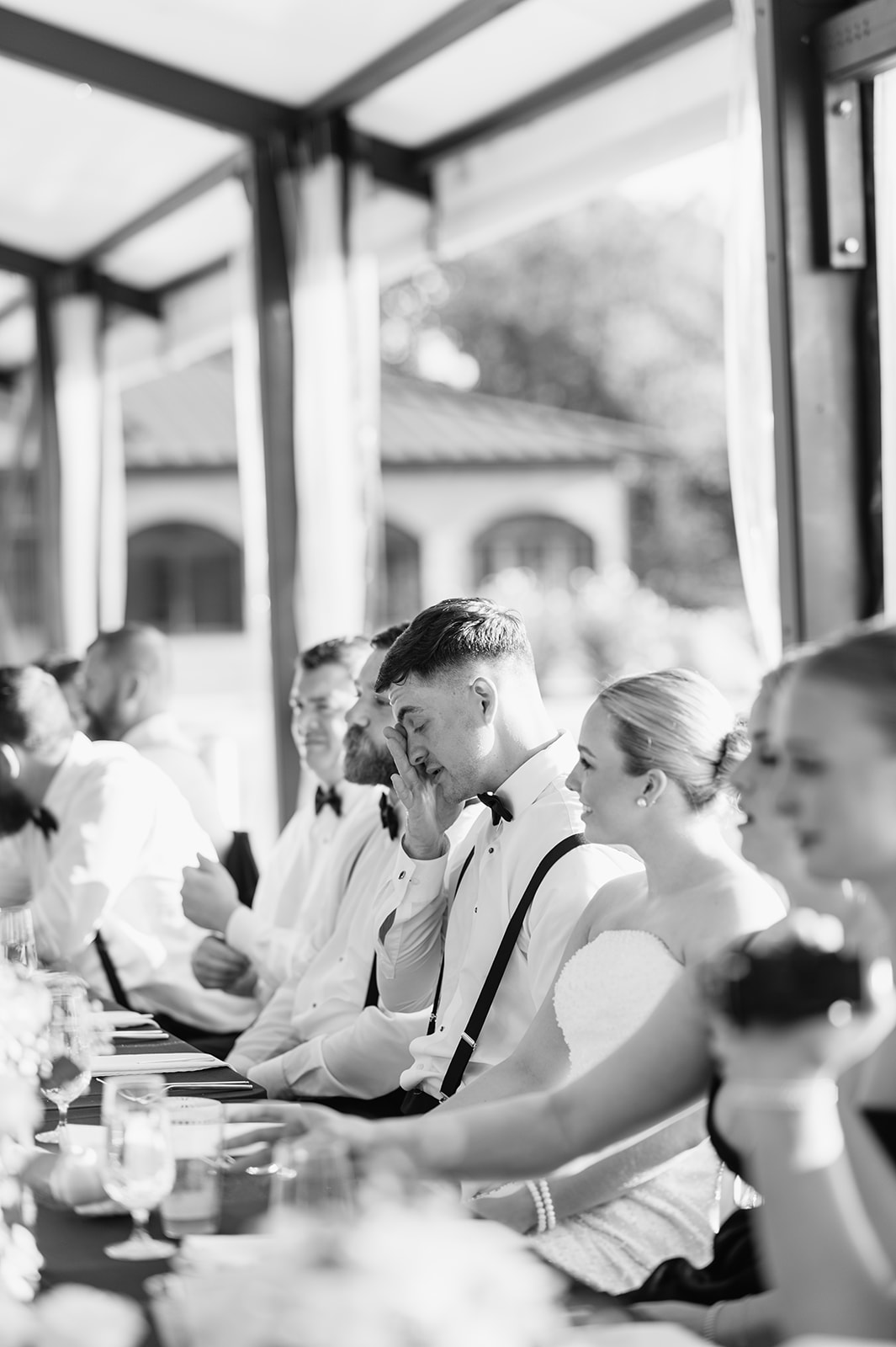 Black and white photo of the groom getting emotional during speeches
