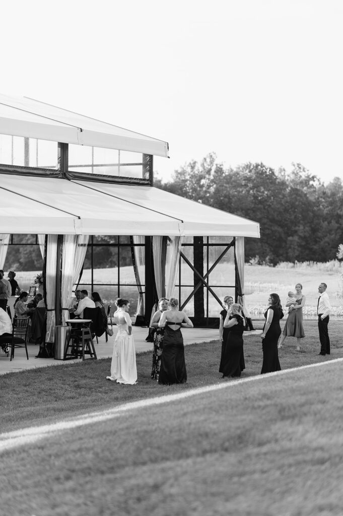 Black and white photo of guests mingling outside of The Clubhouse Venue in Huntington, Indiana