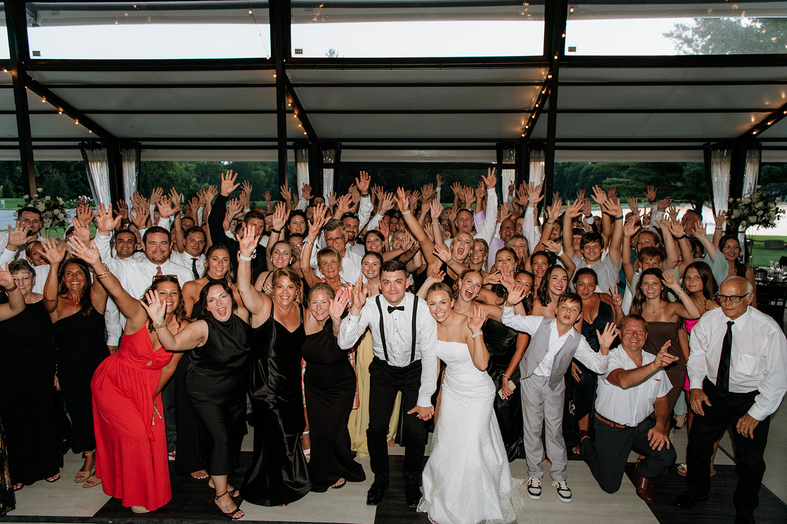 Large group photo of wedding guests celebrating at The Clubhouse Venue reception.