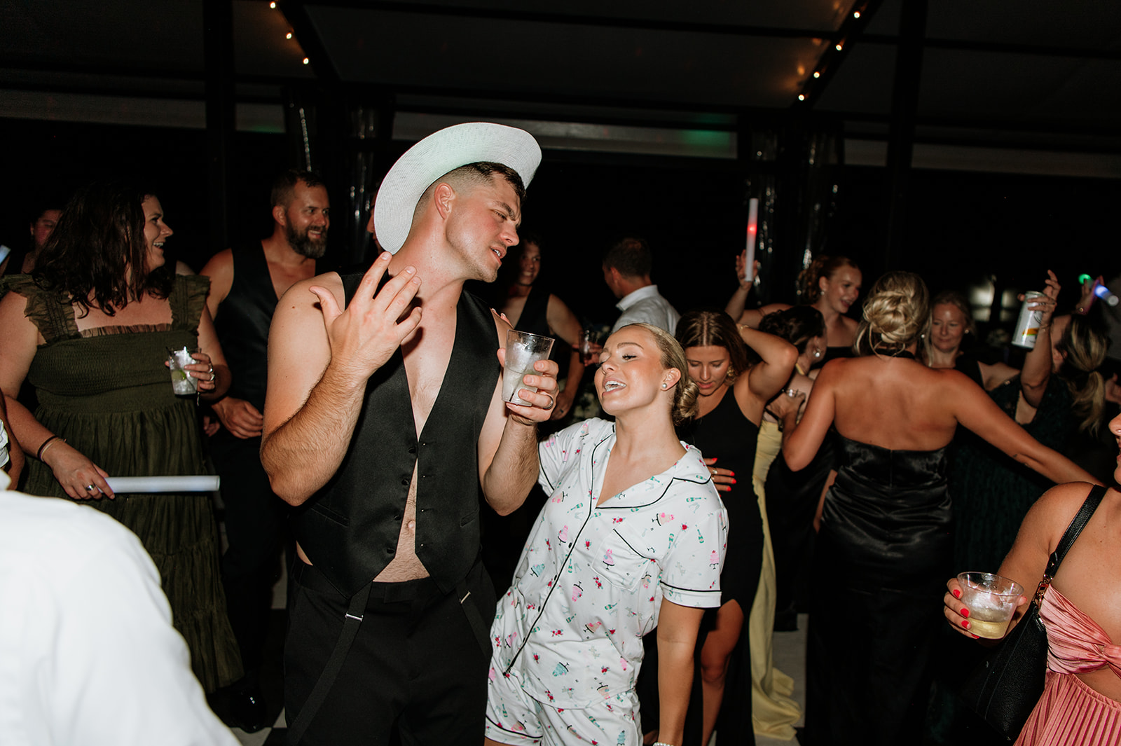 Bride dancing in pajamas with groom at The Clubhouse Venue late-night reception.
