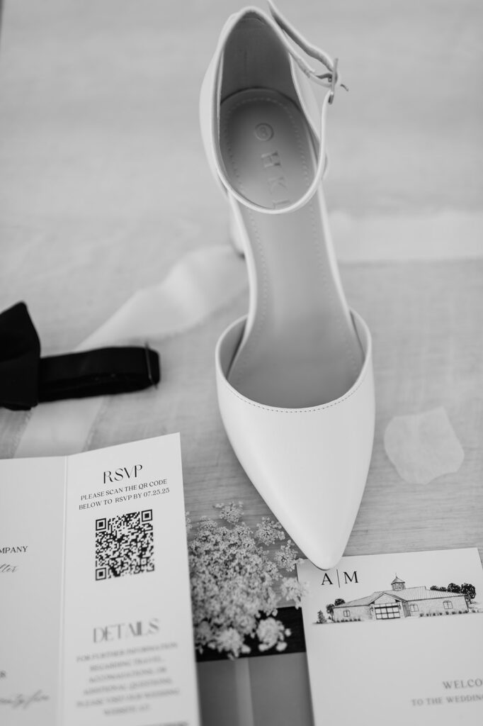 Black and white details of the brides heels and invitation suite