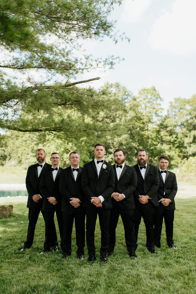 Groomsmen standing together on the lawn at The Clubhouse Venue.