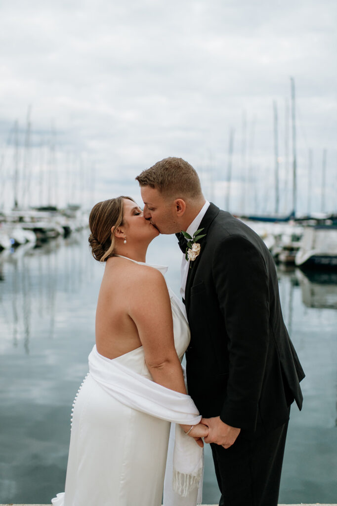  Bride and groom kissing on the dock for their Chicago yacht wedding.