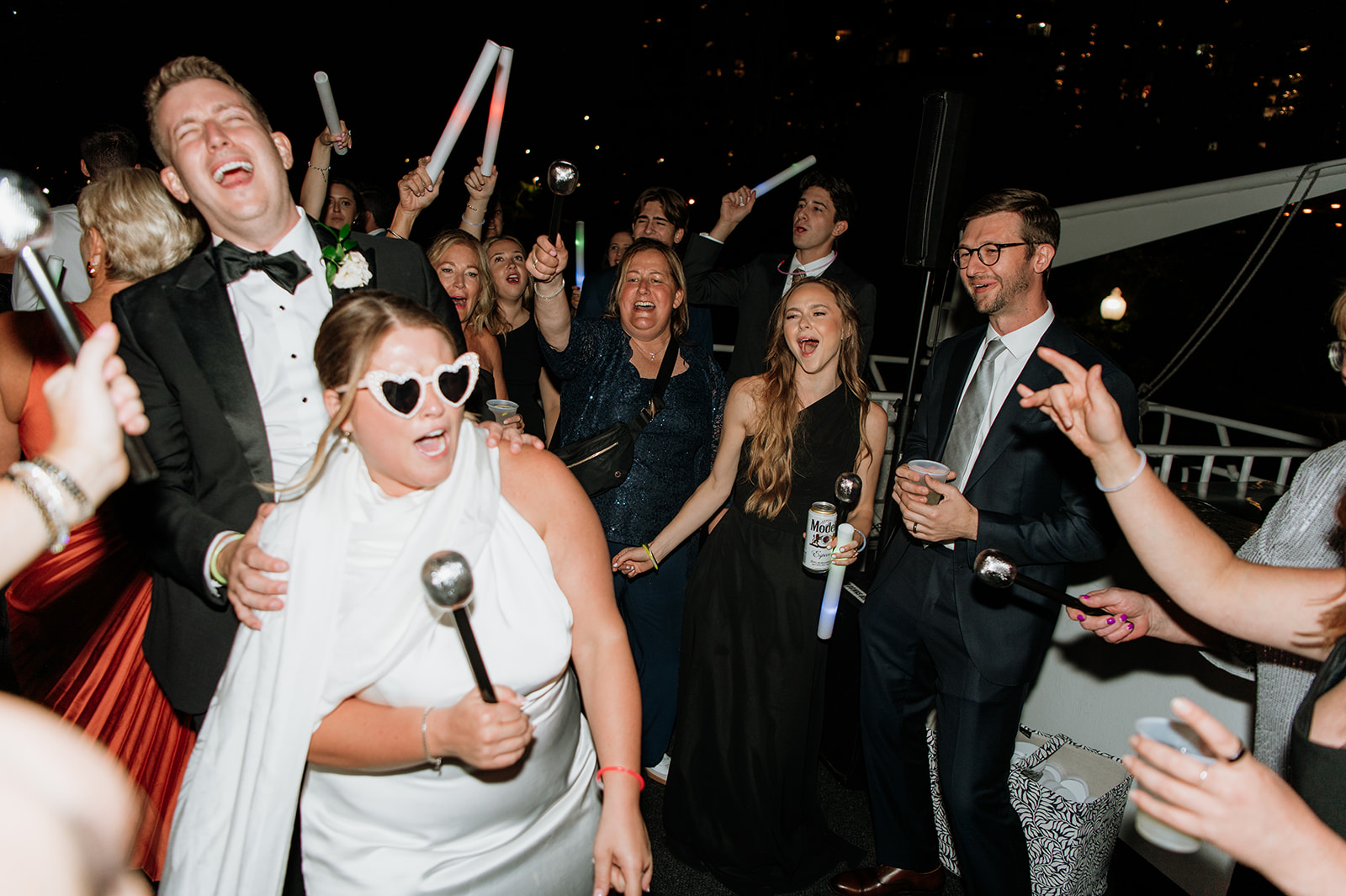 Bride, groom and their guests singing on the Anita Dee II during a Chicago yacht wedding reception.
