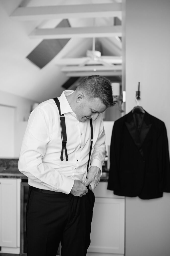 Black and white photo of the groom getting ready for his Chicago wedding.