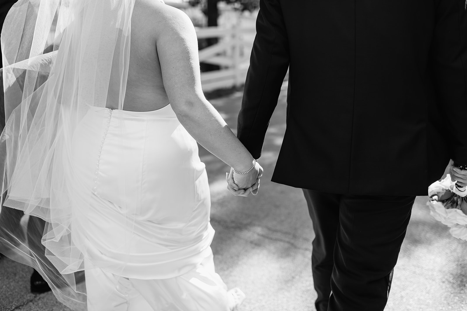 Black and white close up shot of a bride and groom walking together during newlywed portraits in Lincoln Park.