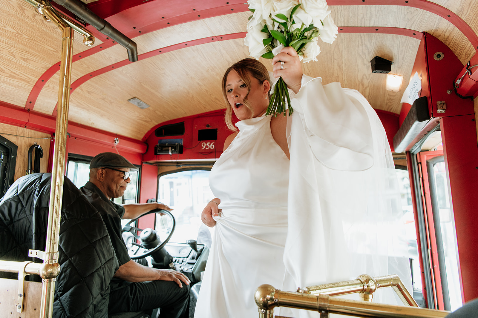 Bride getting onto a trolley in Chicago after her ceremony.