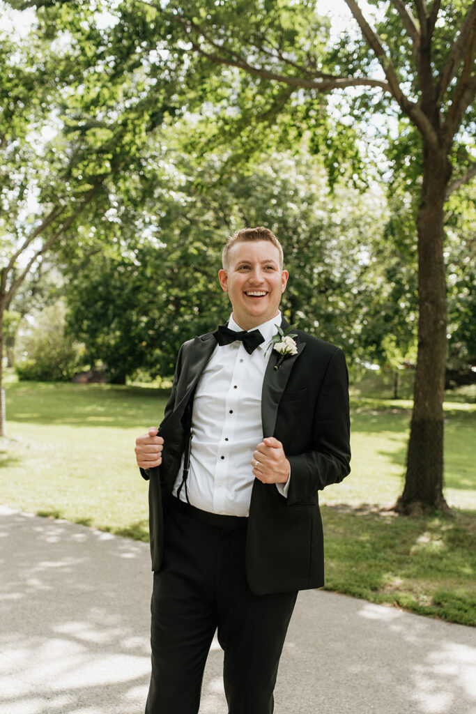 Groom smiling during wedding party portraits in Lincoln Park in Chicago.