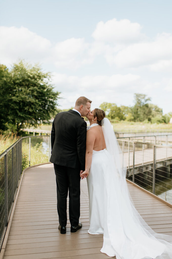 Bride and groom walking a boardwalk at Lincoln Park in Chicago.