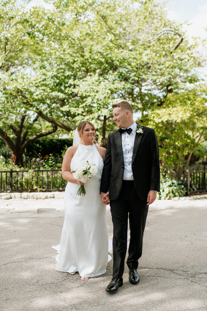 Bride and groom walking together during newlywed portraits in Lincoln Park.